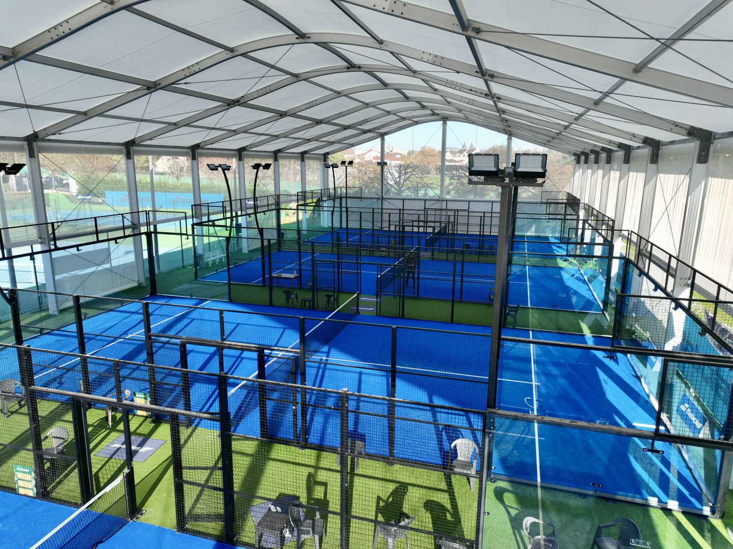 Interior view of a modular indoor padel hall with multiple courts, constructed by Losberger De Boer in Melun, France.